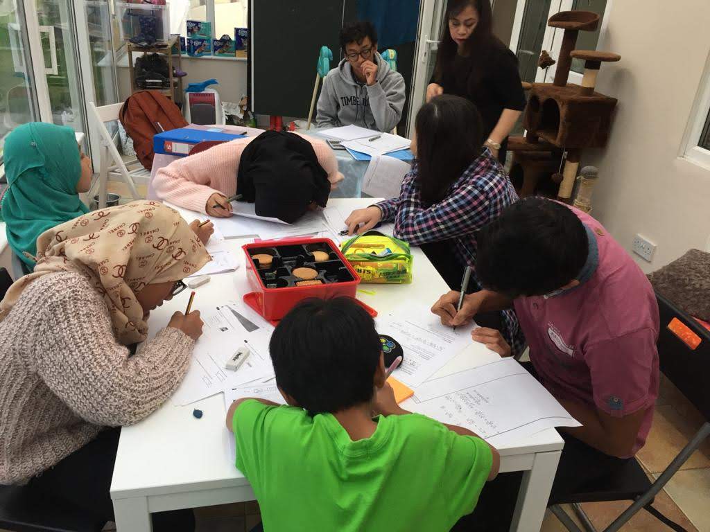 A community study session with children and volunteers seated at tables